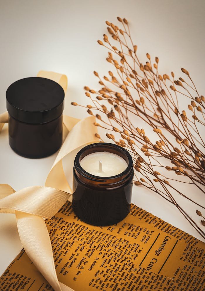 services-02 Aesthetic composition of candles and dried leaves on a vintage paper backdrop.