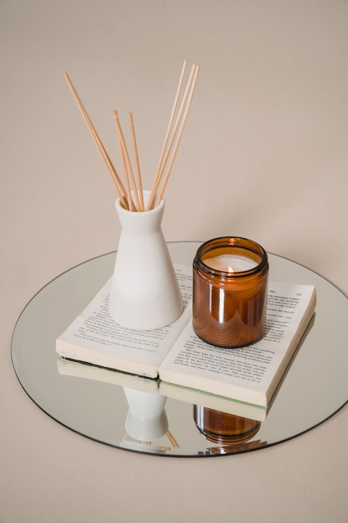 about-img Serene still life of candle and incense on a book reflects tranquility and elegance.